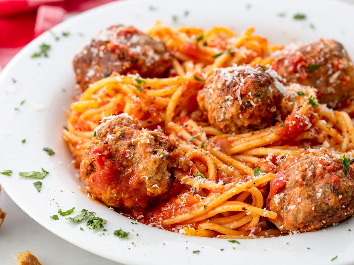 Itallian-American food of spaghetti and meatballs, sprinkled with parsley