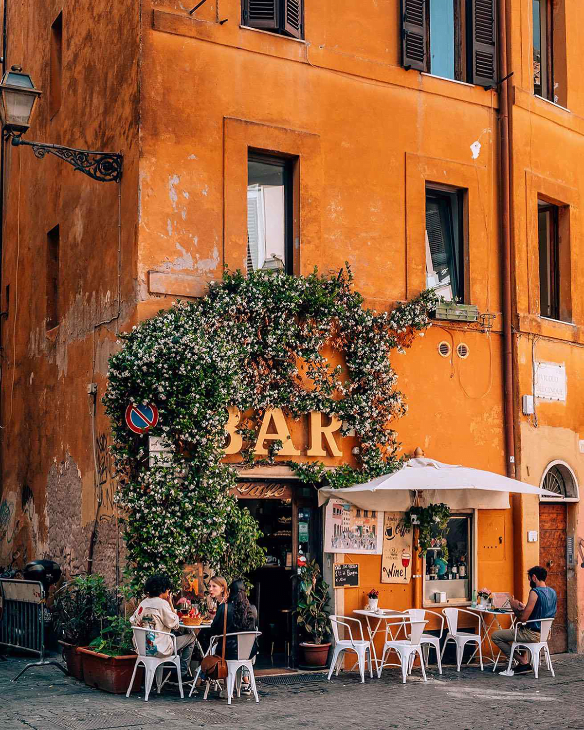 Coffee bar with people sitting outside in Trastevere, Rome