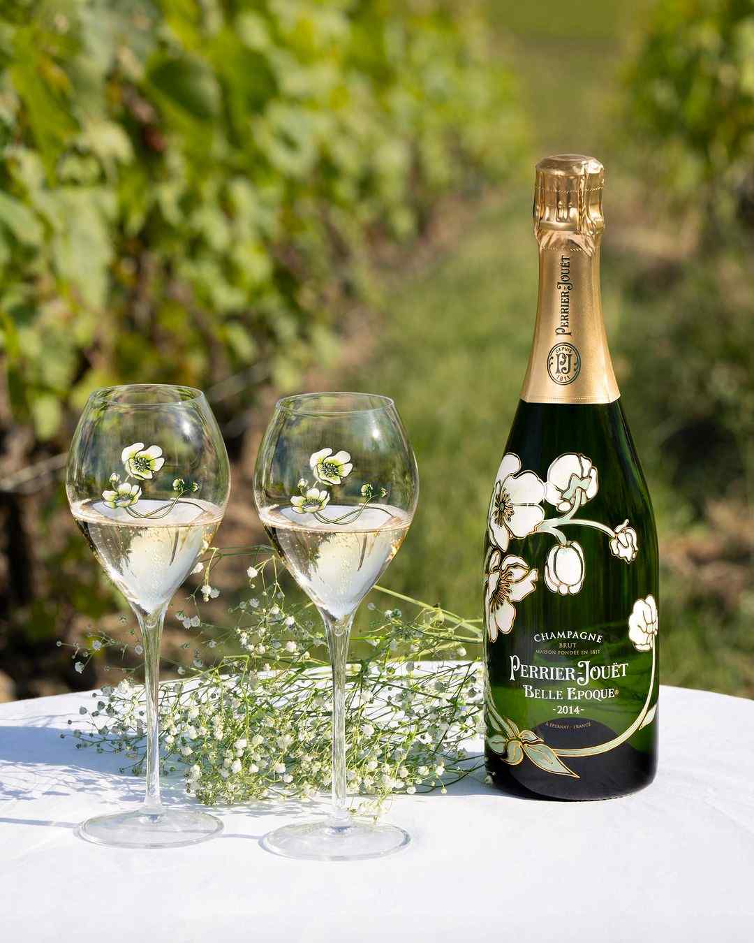 Two glasses filled with champagne on a table