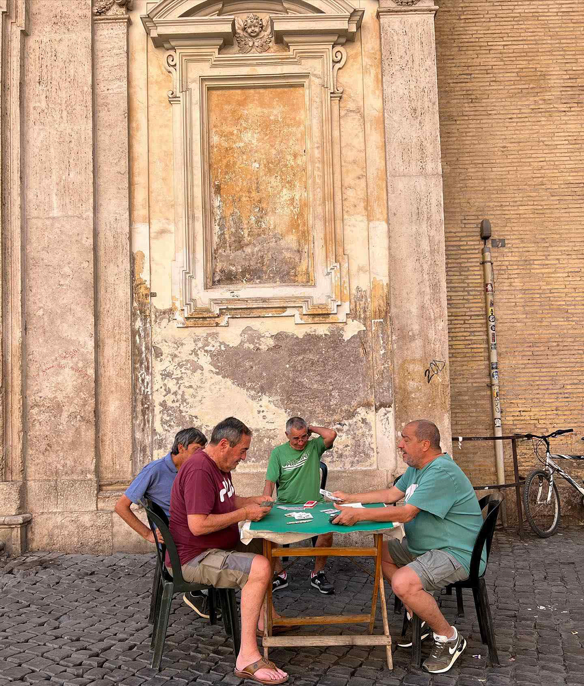 Four men playing cards at a table