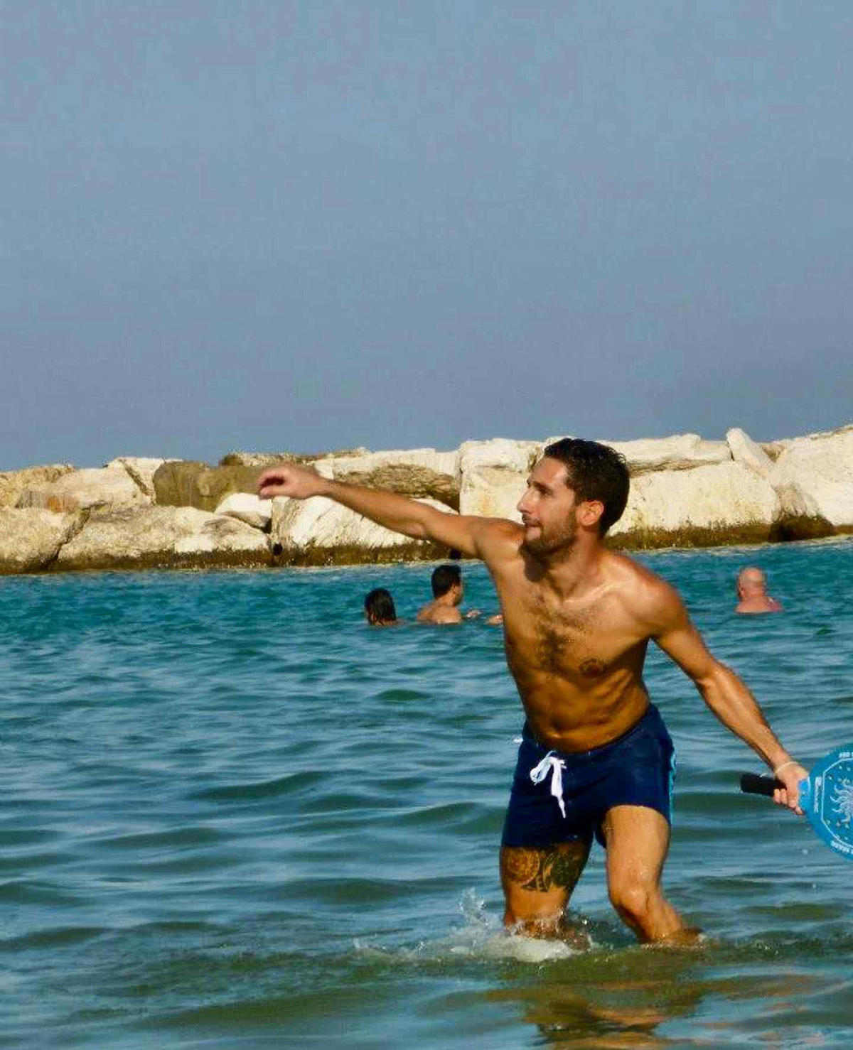 Man playing racchettoni in that sea